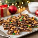 Festive Christmas Crack Recipe topped with chocolate, M&Ms, and crunchy cereal squares